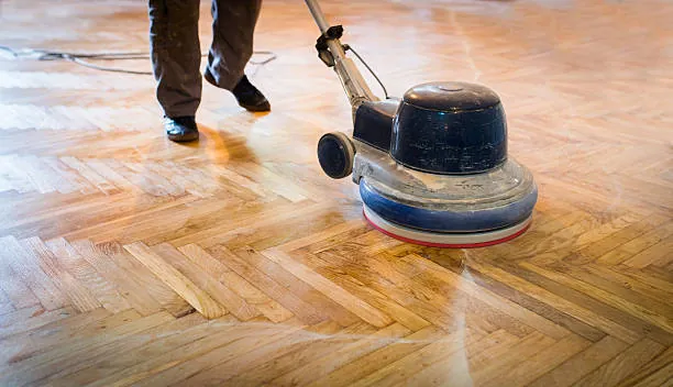 Rotary machine polishing a herringbone parquet floor