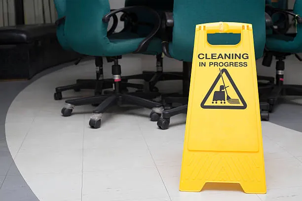 Cleaning in progress sign beside office chairs