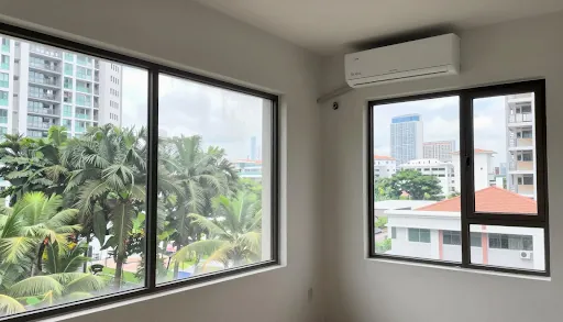 Empty room with windows overlooking greenery