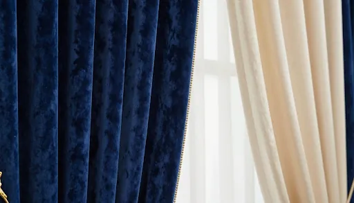 Navy velvet and cream curtains hanging side by side