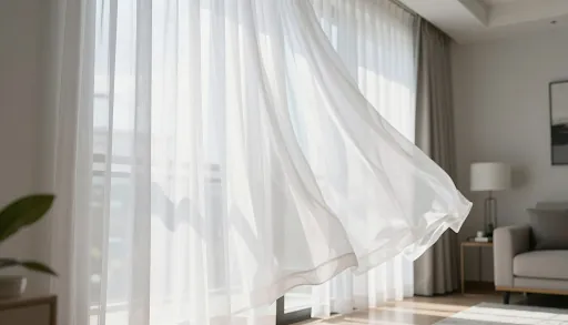 Sheer curtains blowing at an open window