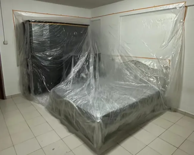 Furniture sealed under plastic sheeting before renovation